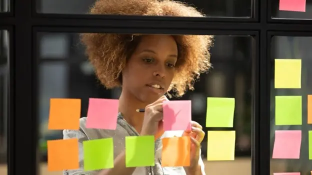woman keeping track on sticky notes